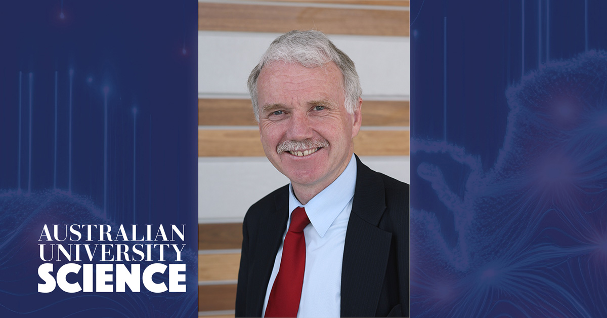 Photo of Professor Aidan Byrne wearing suit and tie on blue background.